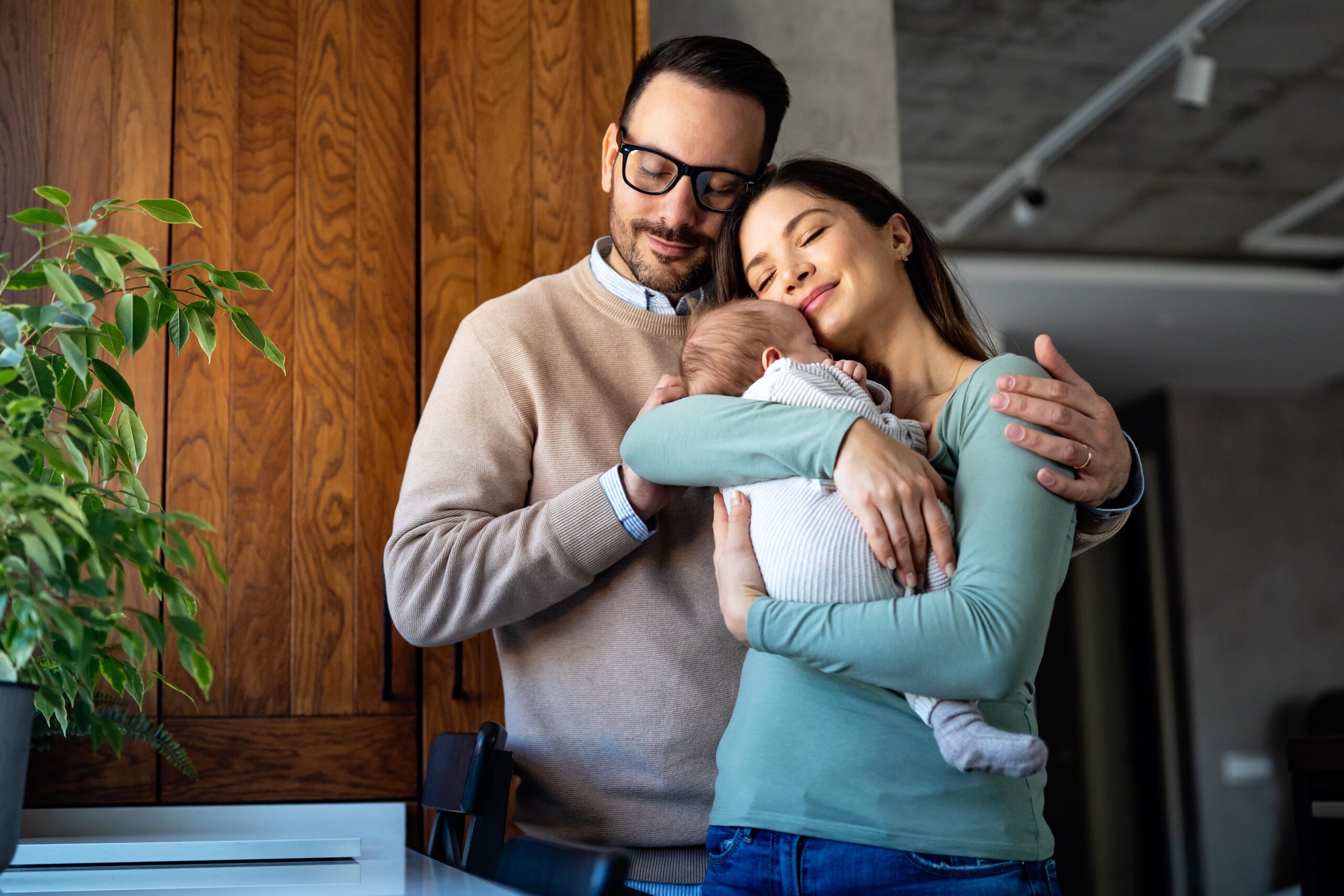Happy couple with newborn at home